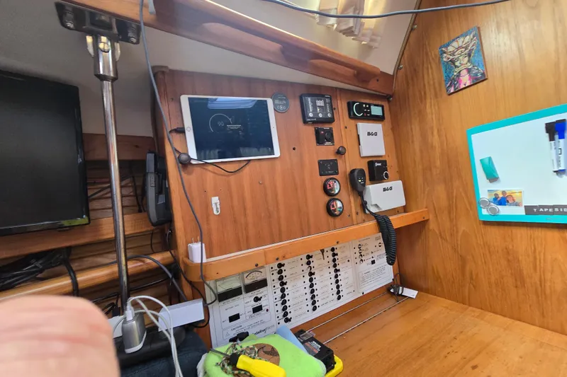 Slide: The Image of Control panel of a 1999 Catalina 380 sailboat with navigation equipment and a tablet. - 40