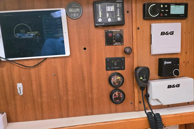 Slide: The Image of Control panel of a 1999 Catalina 380 sailboat with navigation and communication equipment. - 41