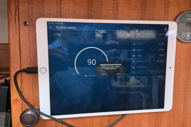 Slide: The Image of Tablet displaying battery status on a 1999 Catalina 380 sailboat, showing 90% charge. - 43