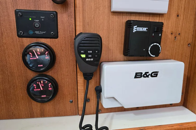 Slide: The Image of Control panel of a 1999 Catalina 380 sailboat with gauges and communication equipment. - 46