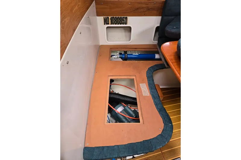 Slide: The Image of Interior view of a 1999 Catalina 380 sailboat, showcasing storage compartments and equipment. - 47