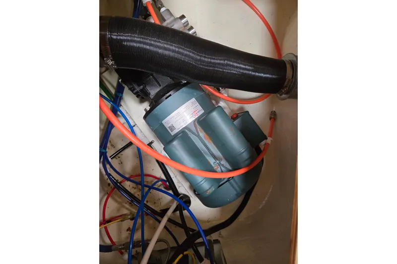 Slide: The Image of Engine compartment of a 1999 Catalina 380 sailboat with visible hoses and wiring. - 48