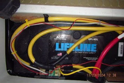 Slide: The Image of AGM battery with yellow and red cables in a 1999 Catalina 380 boat. - 52