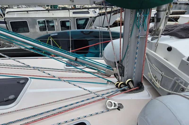 Slide: The Image of Deck of a 1999 Catalina 380 sailboat with rigging and ropes in a marina. - 6