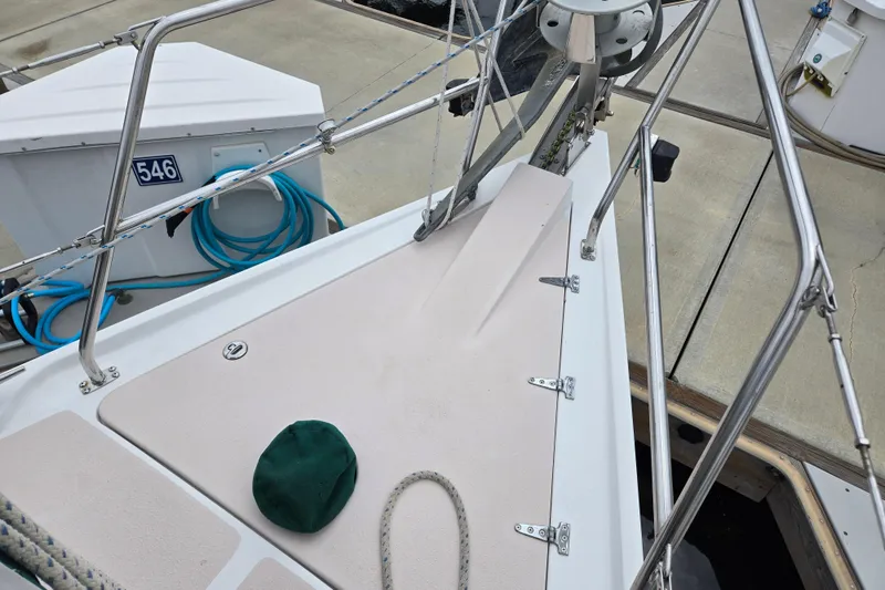 Slide: The Image of Bow of a 1999 Catalina 380 sailboat docked, featuring deck fittings and mooring lines. - 8
