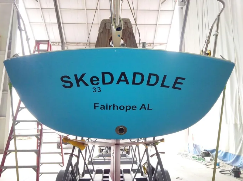 Slide: The Image of Rear view of a blue 2008 e33 sailing yacht named SKeDADDLE. - 19