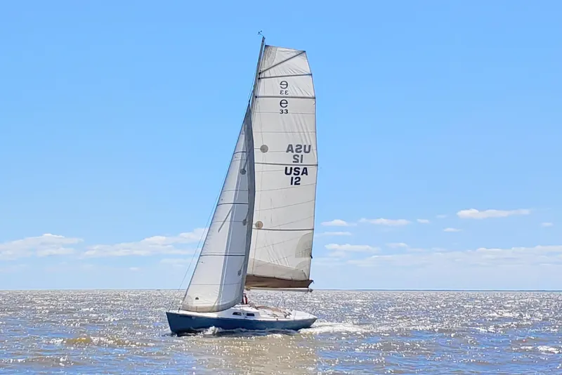 Slide: The Image of 2008 e Sailing Yachts e33 on open water under clear skies. - 4