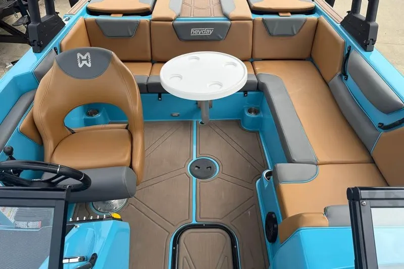 Slide: The Image of 2022 Heyday WT-2DC boat interior with tan seating and a round table. - 11