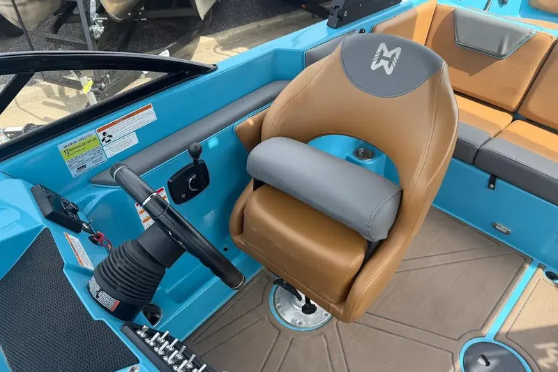 Slide: The Image of 2022 Heyday WT-2DC boat interior with steering wheel and tan seating. - 13
