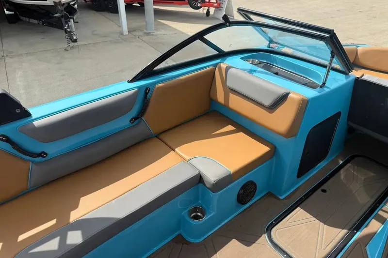Slide: The Image of 2022 Heyday WT-2DC boat interior with tan and gray seating, blue accents. - 16