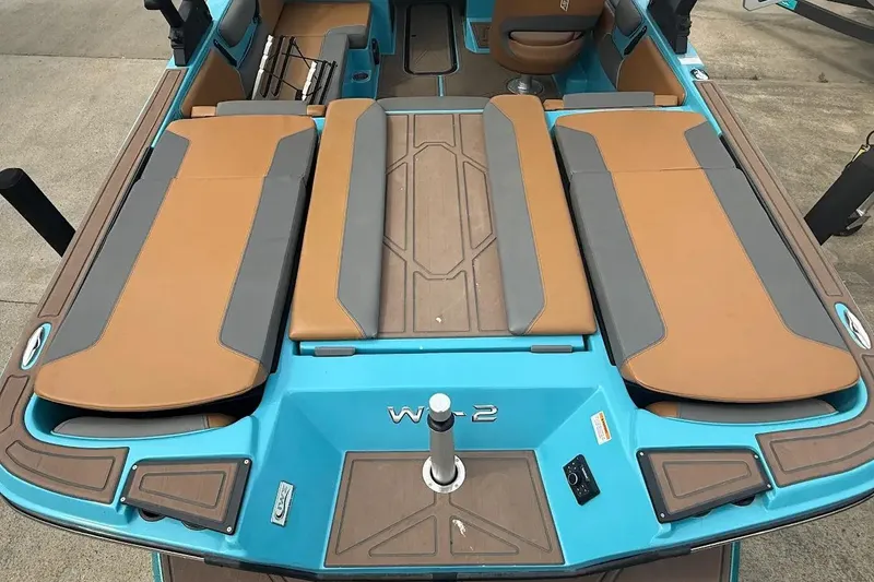 Slide: The Image of 2022 Heyday WT-2DC boat interior with tan and gray seating, blue accents, and modern design. - 22