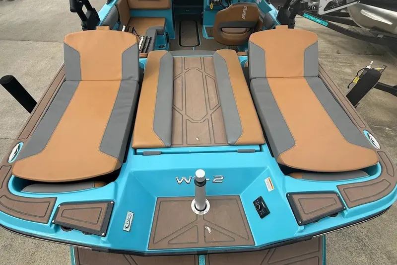 Slide: The Image of 2022 Heyday WT-2DC boat interior with tan and gray seating, blue accents. - 23