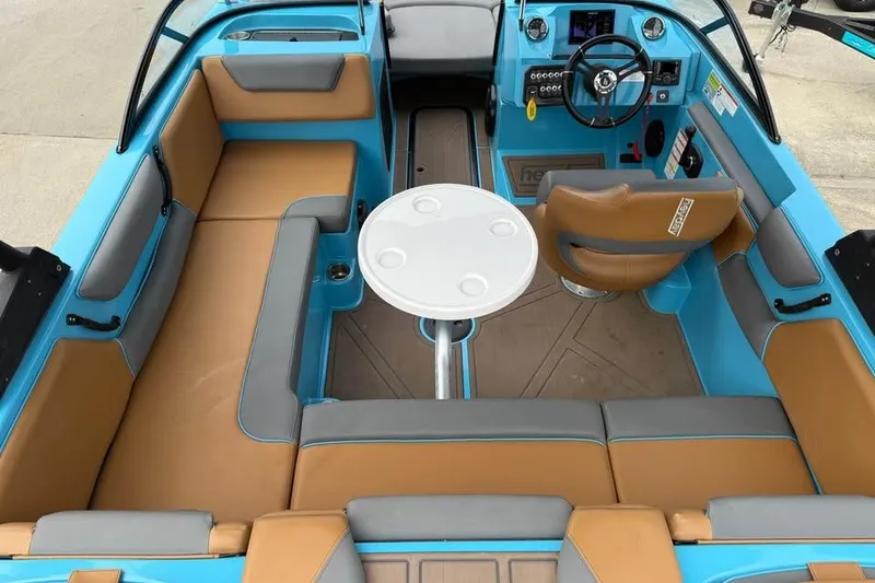Slide: The Image of 2022 Heyday WT-2DC boat interior with tan and gray seating, round table, and steering console. - 24