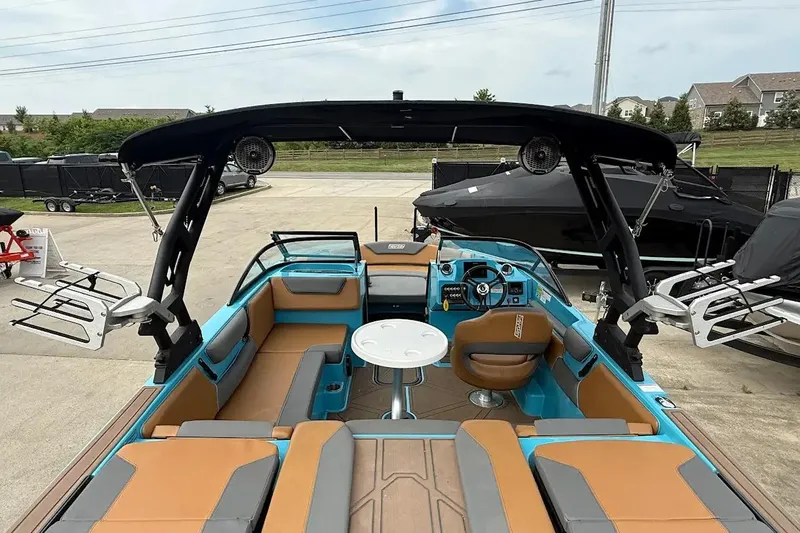 Slide: The Image of 2022 Heyday WT-2DC boat interior with seating, steering wheel, and wakeboard racks. - 25