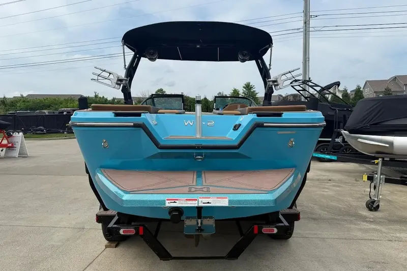 Slide: The Image of 2022 Heyday WT-2DC boat in vibrant blue, parked on a trailer, rear view. - 3