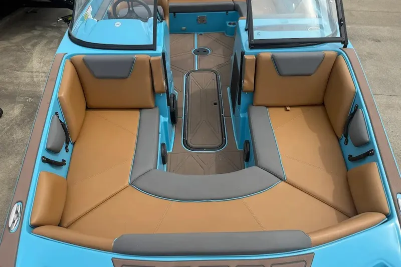 Slide: The Image of 2022 Heyday WT-2DC boat interior with tan and gray seating, blue accents. - 7
