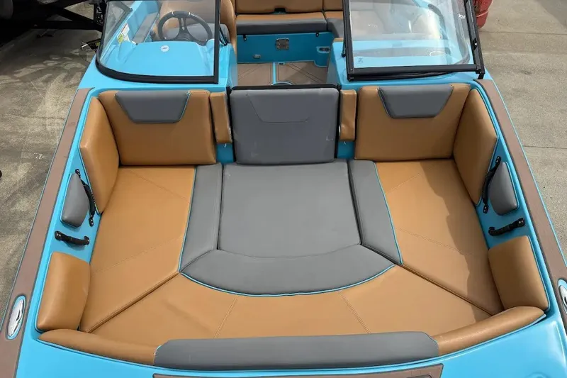 Slide: The Image of 2022 Heyday WT-2DC boat interior with tan and gray seating, blue accents. - 8
