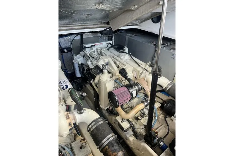 Slide: The Image of Engine room of a 2003 Sea Ray 410 Express Cruiser, showcasing dual engines and components. - 13