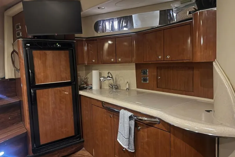 Slide: The Image of Luxurious 2003 Sea Ray 410 Express Cruiser kitchen with wood cabinetry and modern appliances. - 7