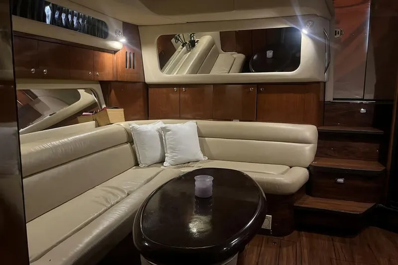 Slide: The Image of Luxurious interior of 2003 Sea Ray 410 Express Cruiser with leather seating and wooden accents. - 8