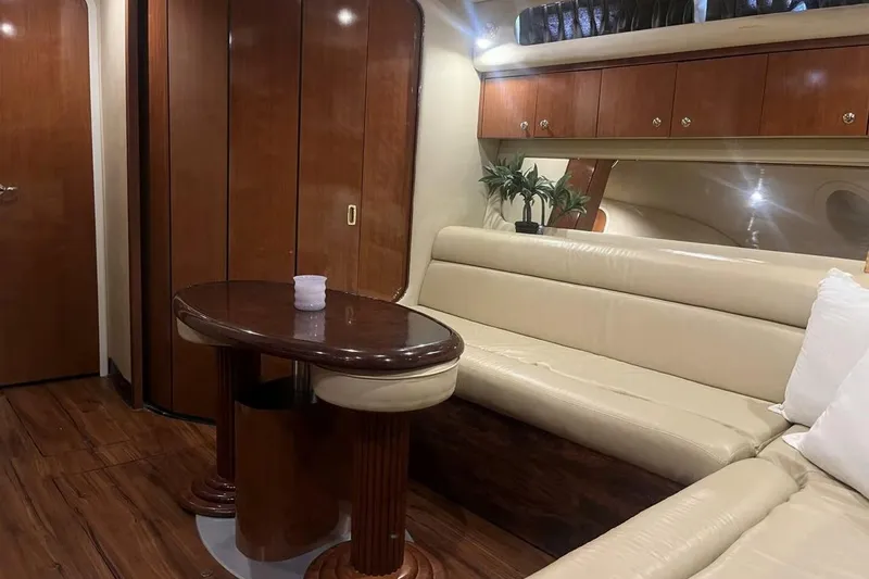 Slide: The Image of Luxurious interior of 2003 Sea Ray 410 Express Cruiser with leather seating and wooden accents. - 9