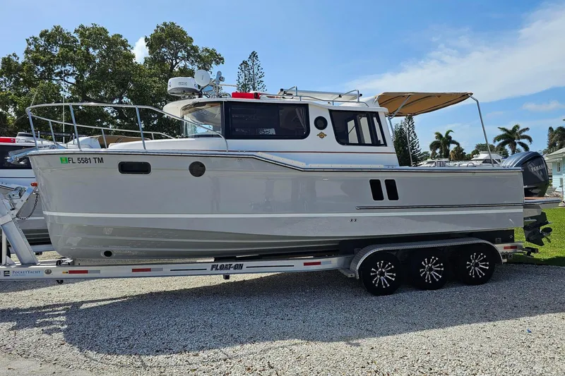 The Image of 2023 Ranger Tugs boat on trailer, parked outdoors under clear sky. - 0