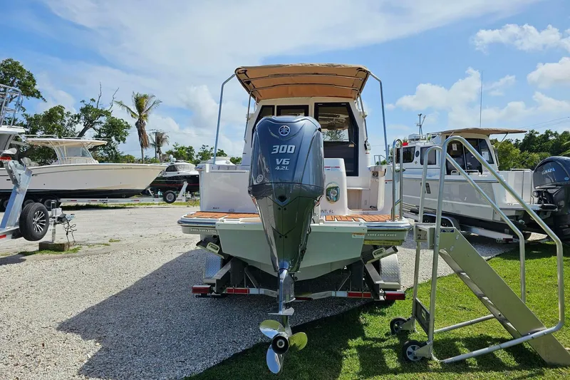 Slide: The Image of 2023 Ranger Tugs boat with Yamaha 300 V6 engine, parked outdoors on a sunny day. - 5