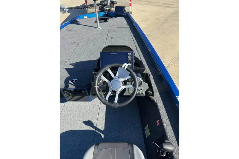 Slide: The Image of Interior view of 2026 Lund 1975 Renegade boat with steering wheel and control panel. - 13