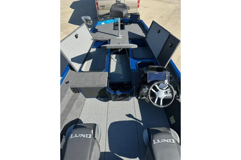 Slide: The Image of 2026 Lund 1975 Renegade boat interior with steering wheel and storage compartments. - 14
