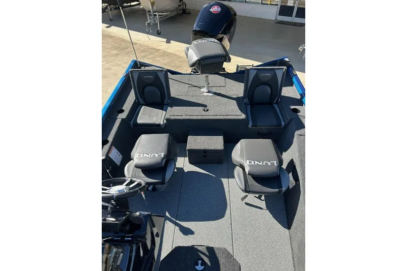 Slide: The Image of 2026 Lund 1975 Renegade boat interior with seating and motor, showcasing modern design. - 15