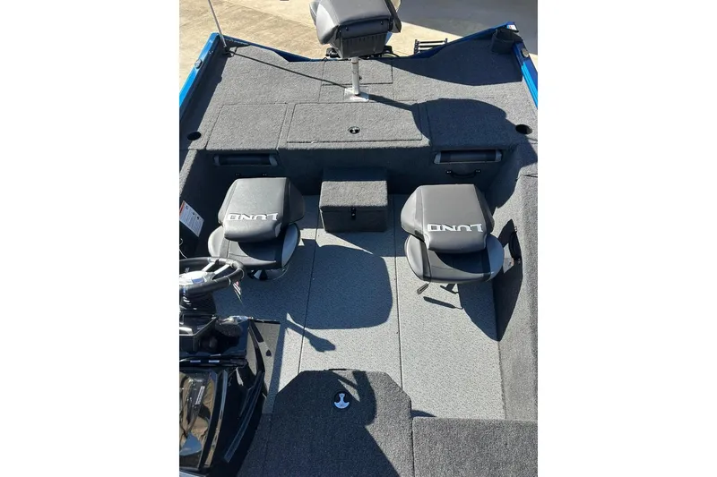 Slide: The Image of Interior of 2026 Lund 1975 Renegade boat with two seats and carpeted flooring. - 16