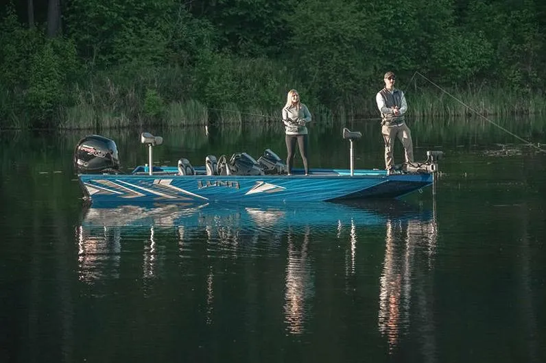 Slide: The Image of Manufacturer Provided Image: Two people fishing on a 2025 Lund 1975 Renegade boat in a serene lake. - 24