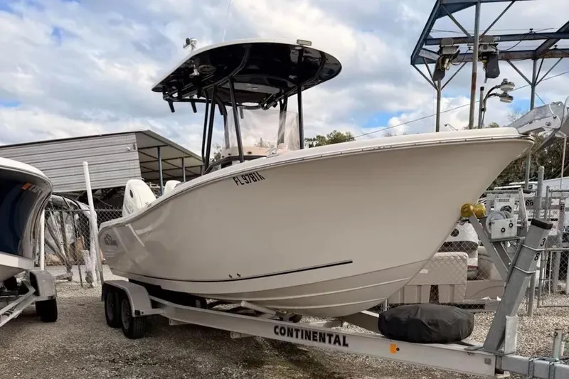 The Image of 2019 Sea Chaser 24 HFC boat on trailer, parked outdoors under cloudy sky. - 0