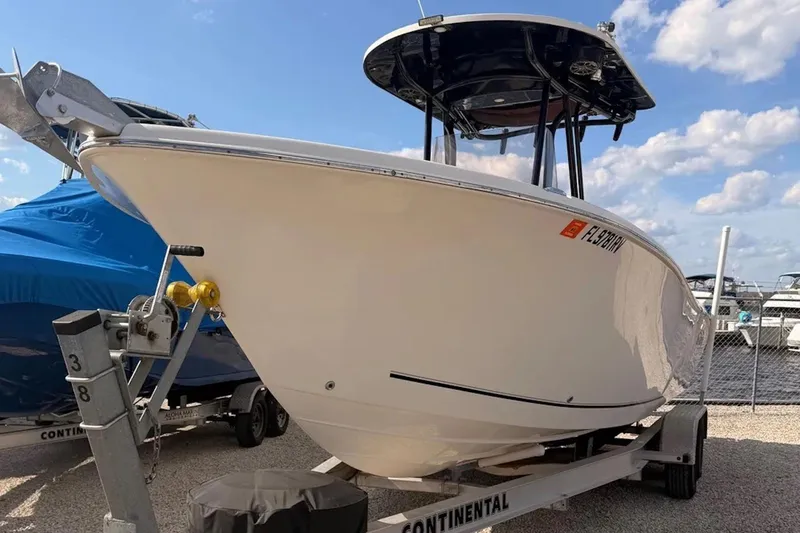Slide: The Image of 2019 Sea Chaser 24 HFC boat on trailer, parked outdoors under blue sky. - 1