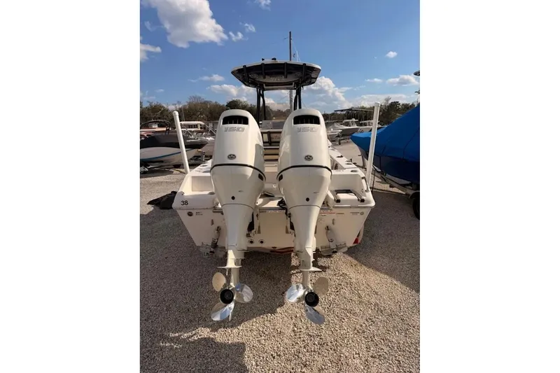 Slide: The Image of 2019 Sea Chaser 24 HFC boat with dual outboard motors, parked outdoors. - 4