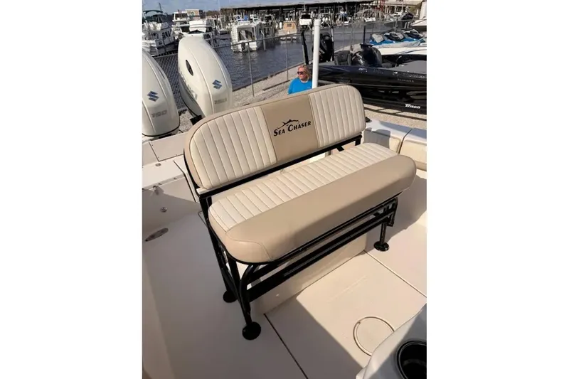 Slide: The Image of 2019 Sea Chaser 24 HFC boat seat with beige upholstery at a marina. - 7