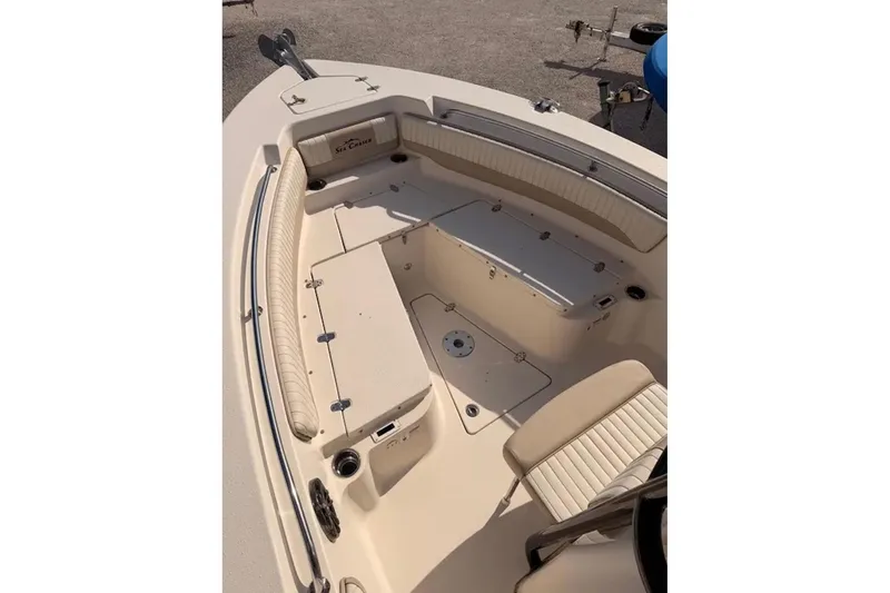 Slide: The Image of 2019 Sea Chaser 24 HFC boat interior with beige seating and storage compartments. - 9