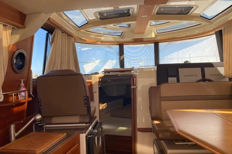 Slide: The Image of Interior of 2020 Ranger Tugs R-29 S with seating, skylights, and navigation equipment. - 9