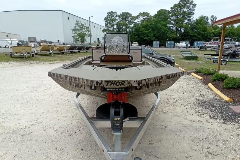 Slide: The Image of 2027 Thor 1900 Bay Hammer boat on trailer, outdoor display with trees and buildings. - 30