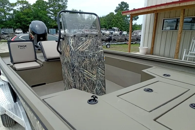 Slide: The Image of 2027 Thor 1900 Bay Hammer boat with camouflage console and dual seats. - 35
