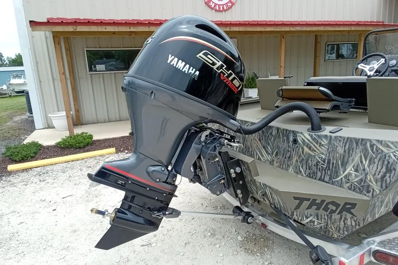 Slide: The Image of Thor 1900 Bay Hammer 2027 boat with Yamaha outboard motor in a rustic setting. - 40