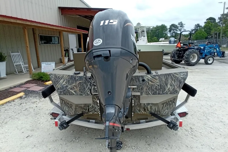 Slide: The Image of Rear view of 2027 Thor 1900 Bay Hammer boat with camouflage design and powerful outboard motor. - 41