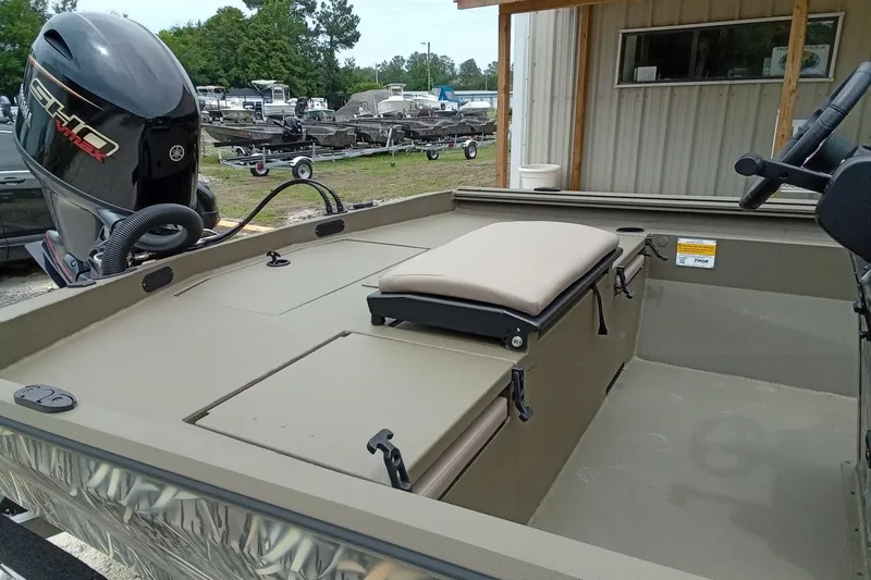 Slide: The Image of 2027 Thor 1900 Bay Hammer boat with Yamaha outboard motor, parked near a building. - 49