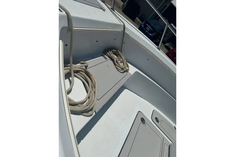 Slide: The Image of 2004 Triumph 210 CC boat interior with coiled ropes on deck. - 12