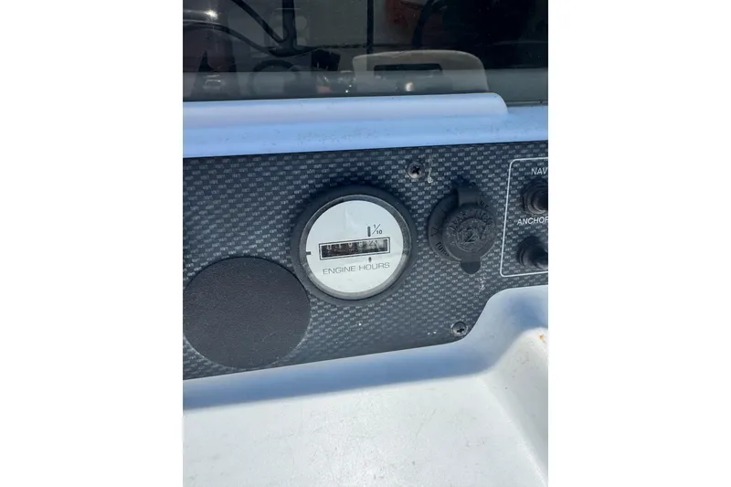 Slide: The Image of Dashboard of a 2004 Triumph 210 CC boat showing engine hours gauge. - 14