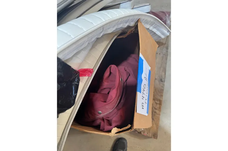 Slide: The Image of Cardboard box with red fabric and white cushions, related to 2004 Triumph 210 CC. - 18