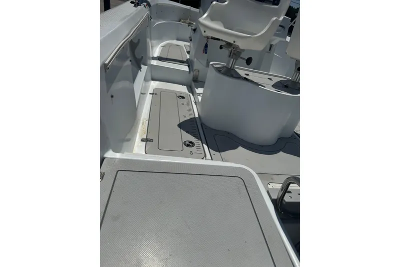 Slide: The Image of 2004 Triumph 210 CC boat interior with seating and storage compartments. - 5