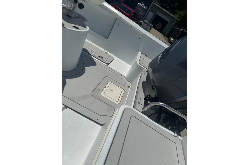 Slide: The Image of 2004 Triumph 210 CC boat interior with engine and seating area. - 6