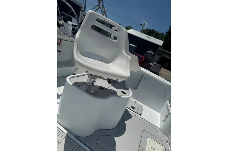 Slide: The Image of White captain's chair on 2004 Triumph 210 CC boat deck under clear sky. - 7