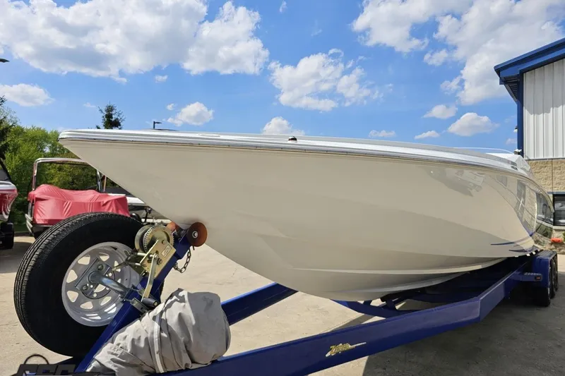 Slide: The Image of 2006 Baja 35 Outlaw boat on trailer under a clear blue sky. - 16